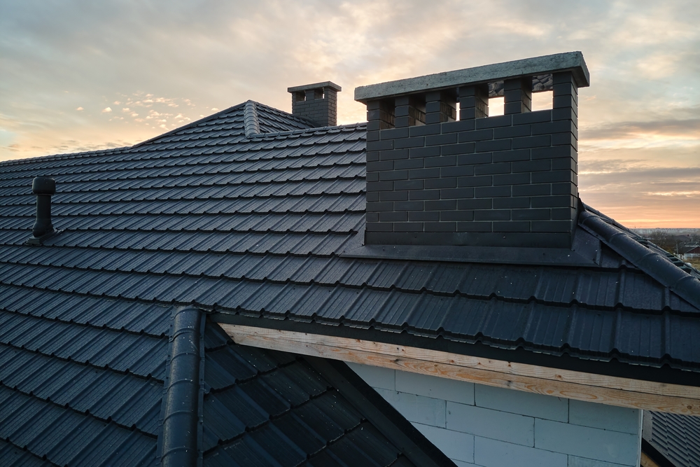 Closeup,of,brick,chimney,on,house,roof,top,covered,with
